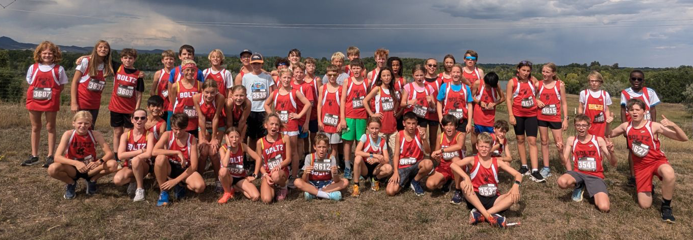 Cross Country team in uniform posing on ridgetop