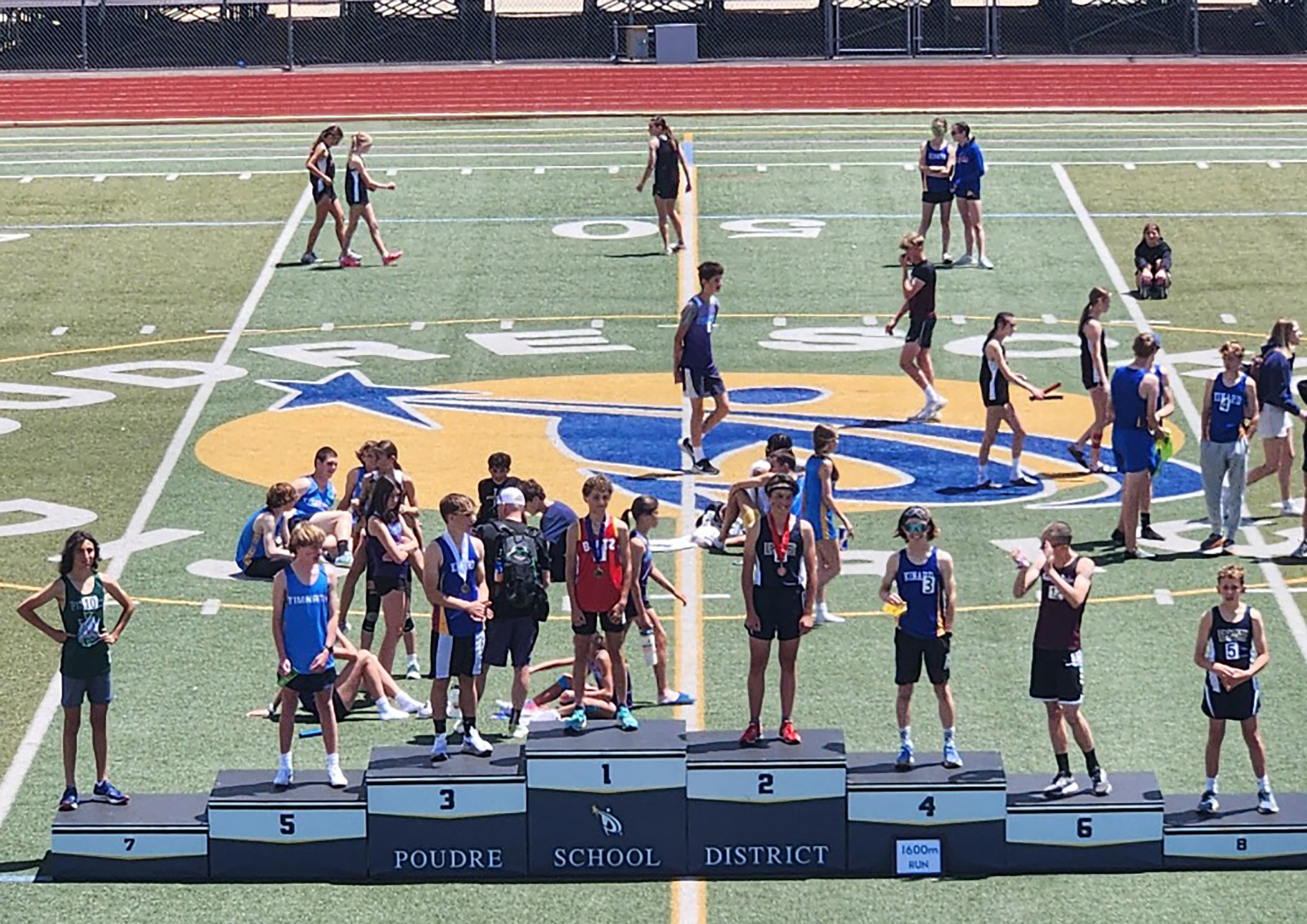 District Track members standing on award podium
