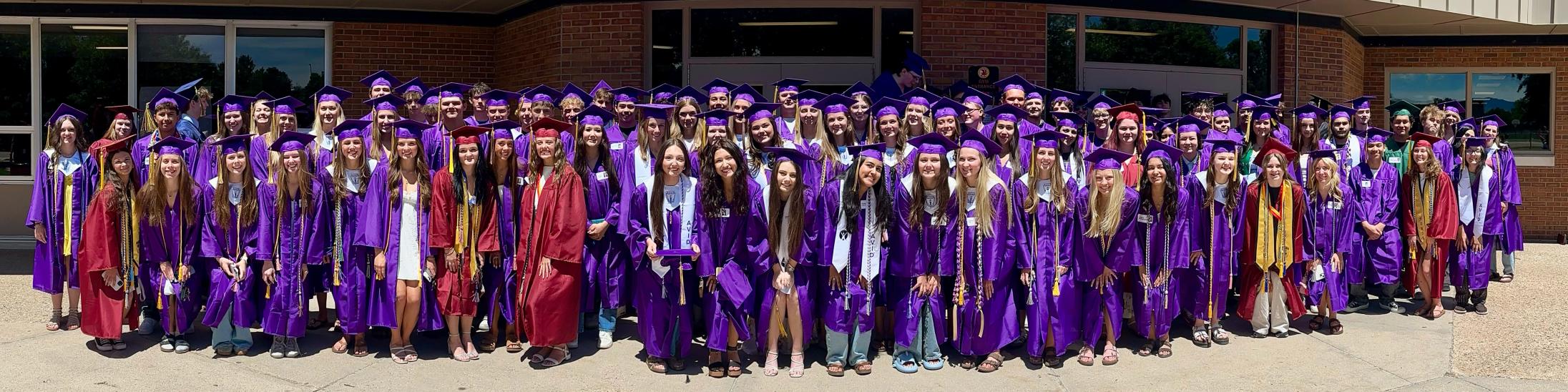 Boltz alumni who are graduating from high schools pose in front of the Boltz building.