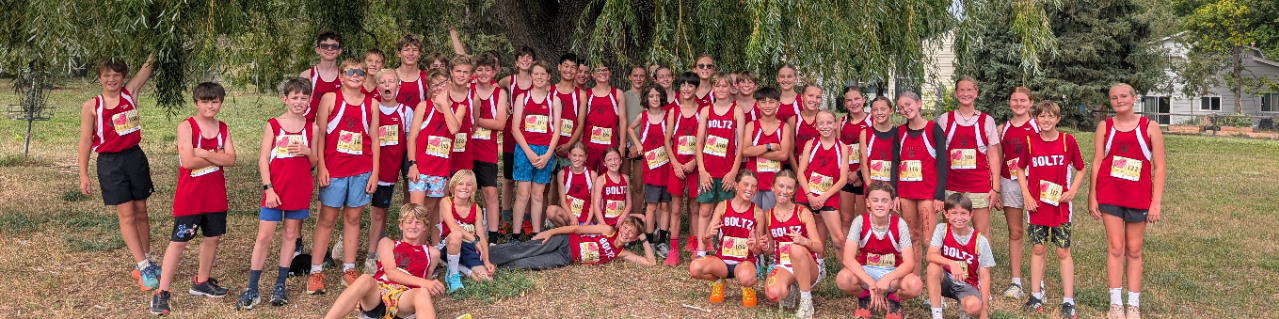 Boltz's cross country team under a willow tree on campus